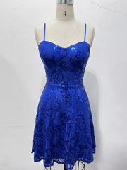 Royal blue floral-sequin mini dress displayed on a dress form.