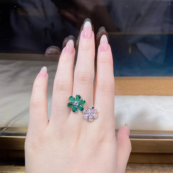 Two flower-shaped ring designs shown side by side, one green and one clear
