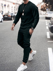 Model wearing black long-sleeve top and jogger pants set