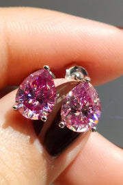 Close-up of pink teardrop stud earrings showing the prong settings