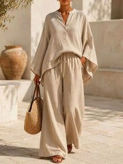 Woman wearing a beige notched-neck top and wide-leg pants set, shown full length.