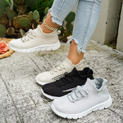 White, black and gray knit lace-up sneakers shown together