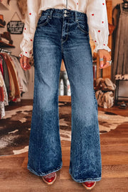 Medium-blue flare jeans worn with red shoes, front view