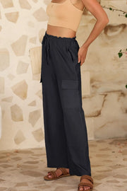 Black utility trousers shown from the side with cargo pocket detail