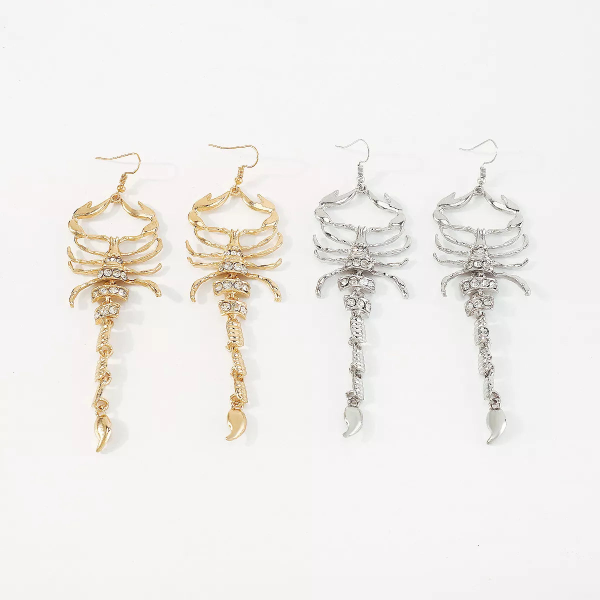 Gold-tone and silver-tone scorpion dangle earrings shown together