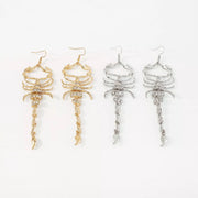 Gold-tone and silver-tone scorpion dangle earrings shown together