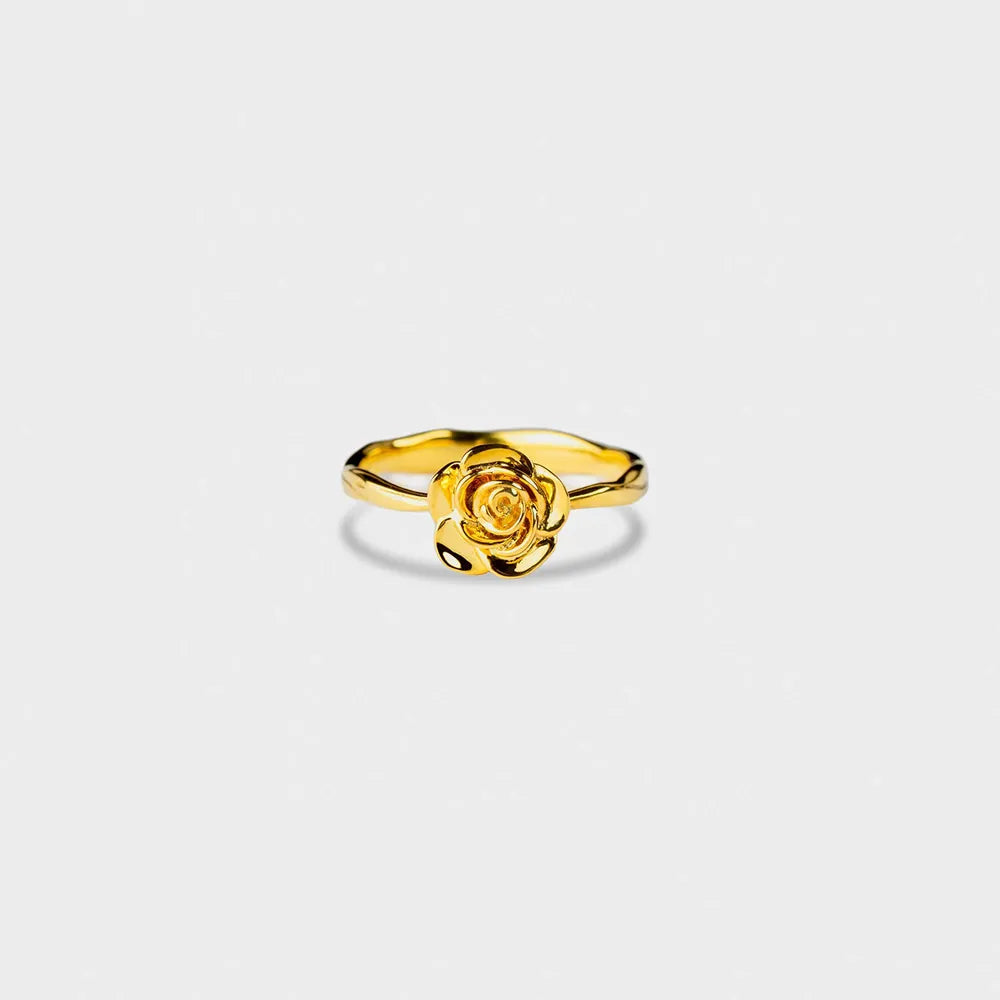Gold-plated rose ring shown from above on a light background