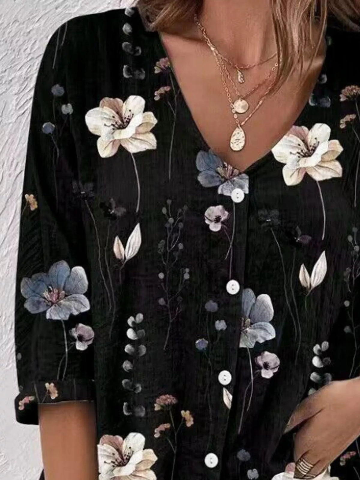 Detail of black blouse fabric with large flower print.