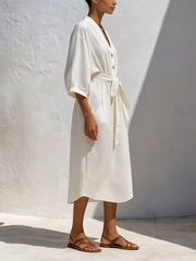 Side view of white button-front midi dress with tie waist