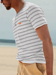 Side view of model wearing gray-and-white striped T-shirt