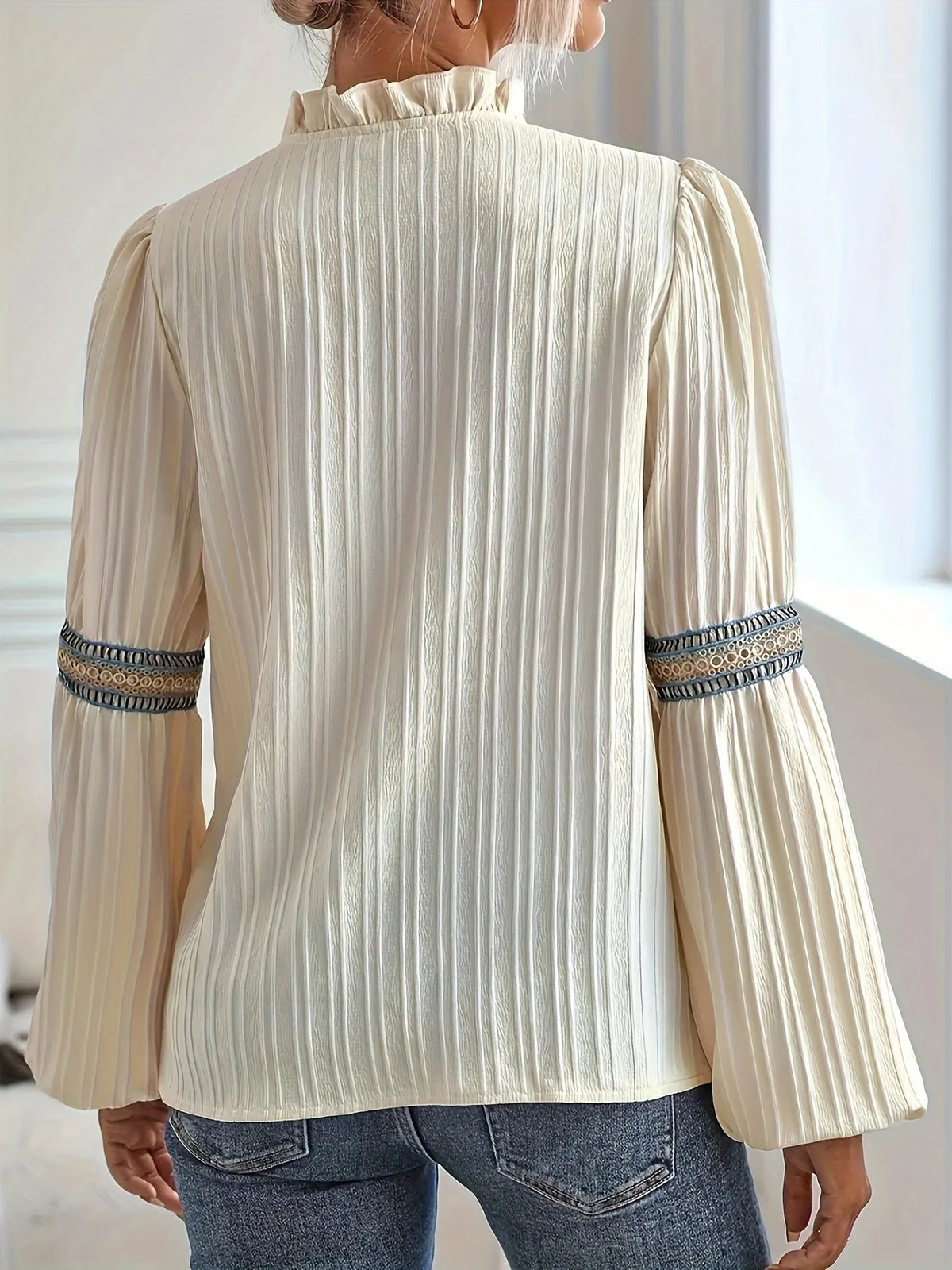 Notched textured balloon-sleeve blouse in cream striped back view