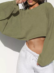 Close-up front view of an olive green cropped sweatshirt.