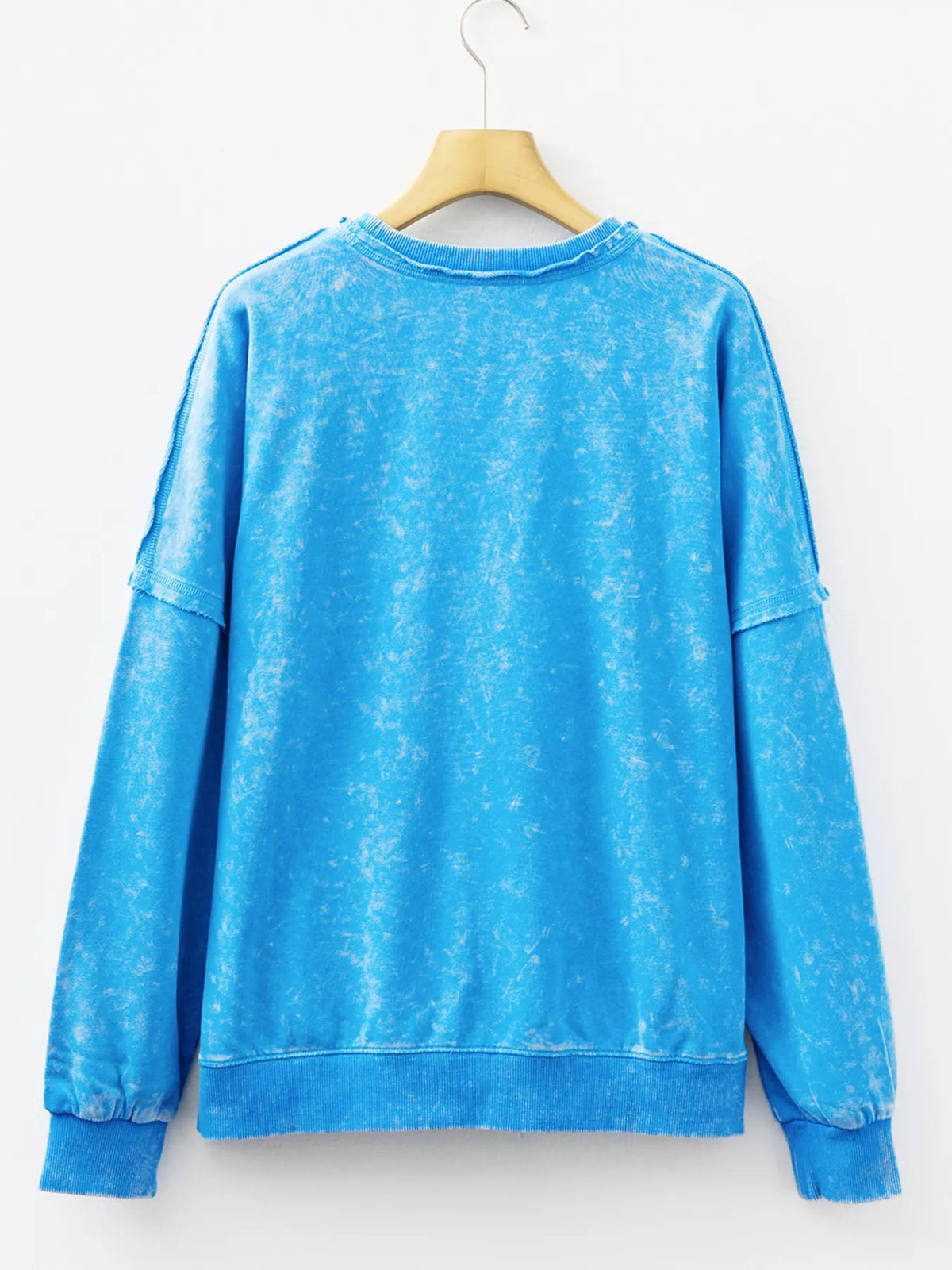 Women's mineral-wash blue raw-seam pocket sweatshirt, back hanging view