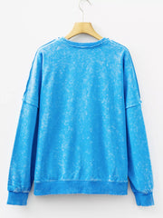 Women's mineral-wash blue raw-seam pocket sweatshirt, back hanging view