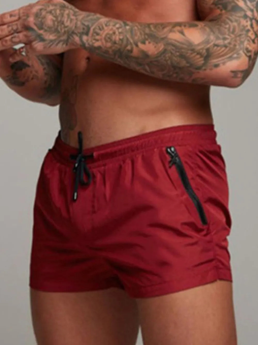Model wearing burgundy drawstring active shorts