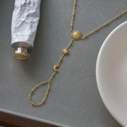 Gold sun charm bracelet arranged in a circular shape