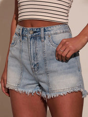 Front view of washed denim shorts with raw hems