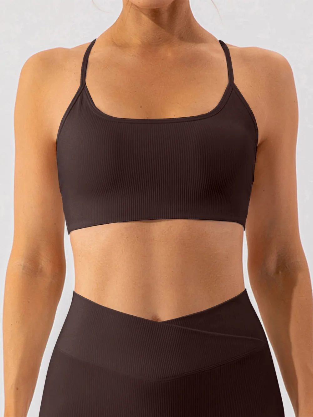 Front view of dark brown spaghetti-strap active bra