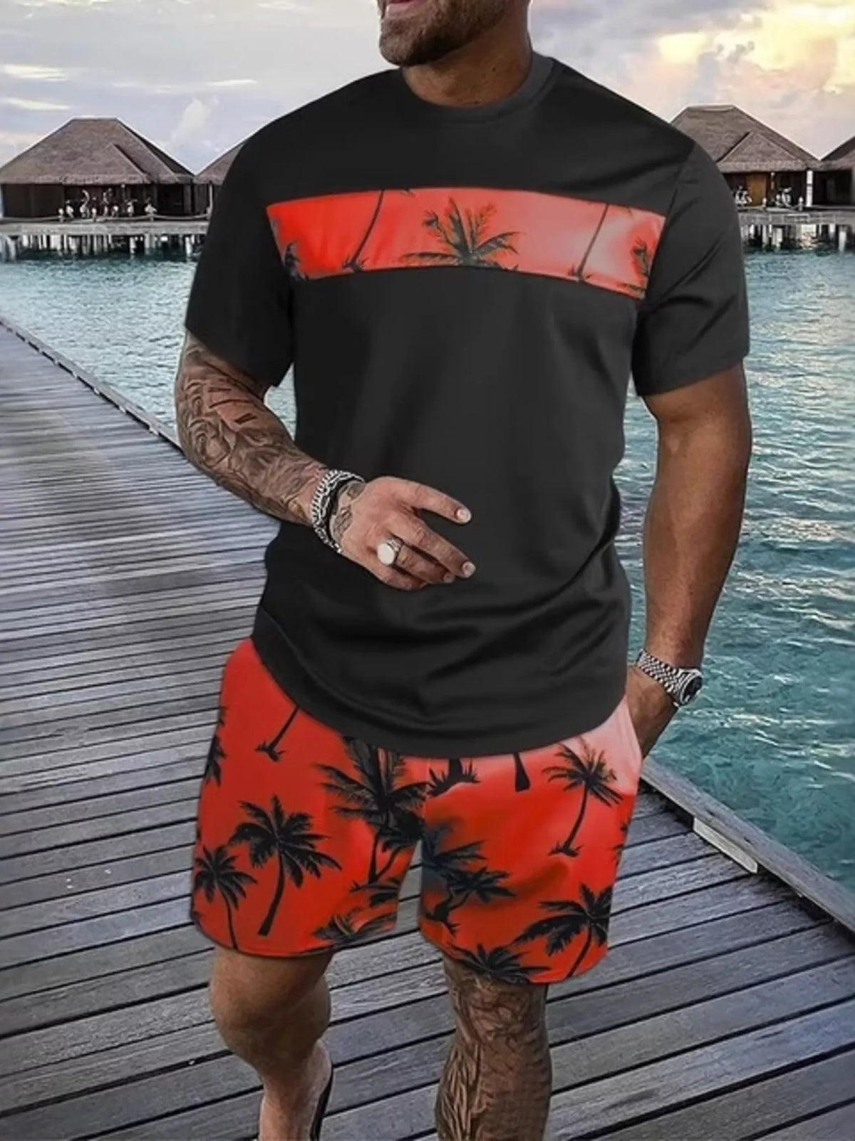 Black short-sleeve tee and shorts set with red-orange panels and palm-tree print.
