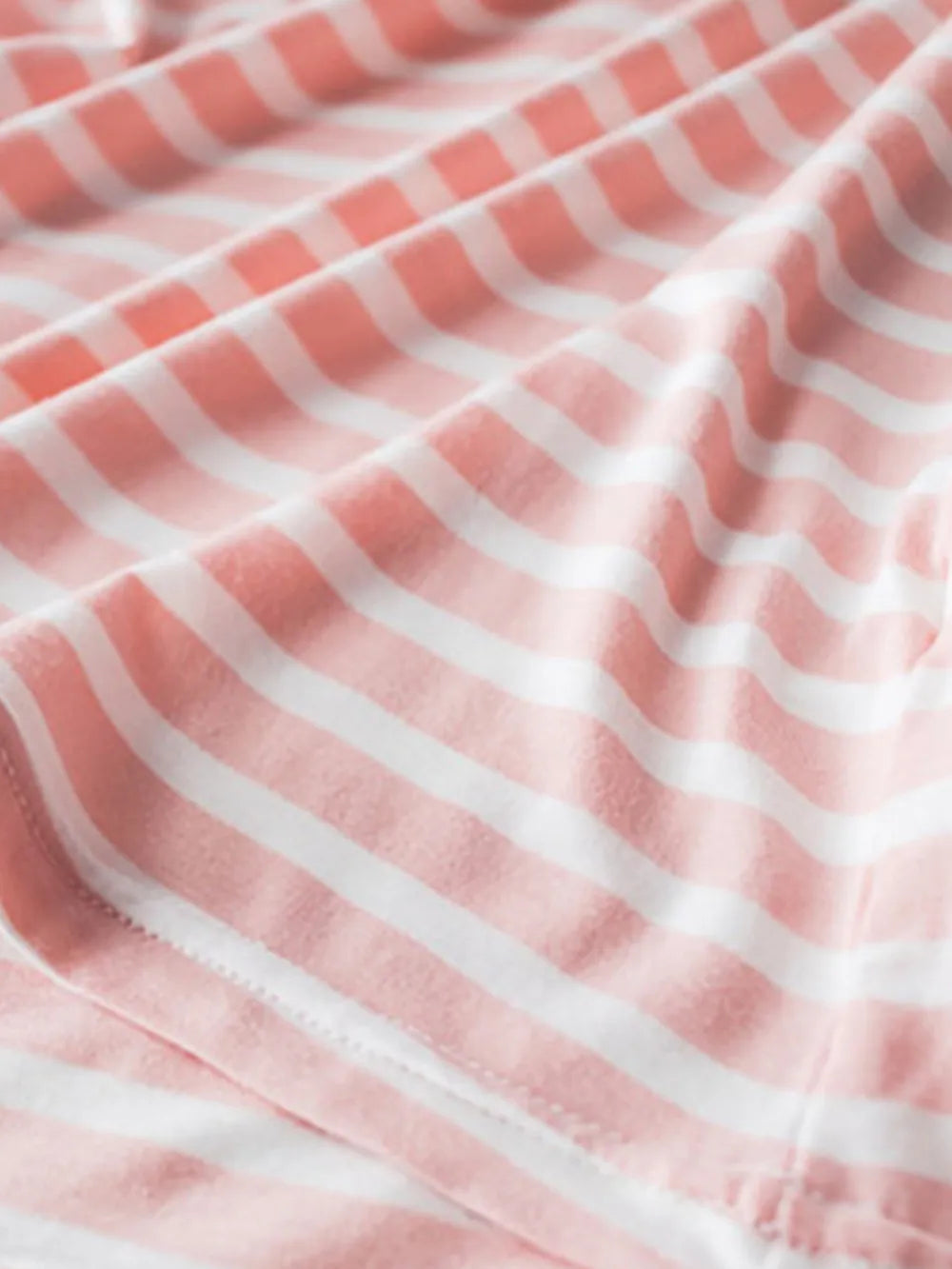 Detail of soft pink-and-white striped shirt fabric