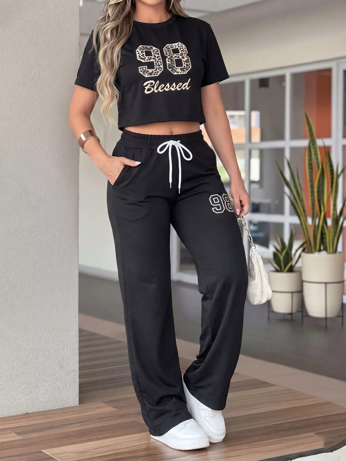 Front view of black 98 Blessed crop top and matching drawstring wide-leg pants