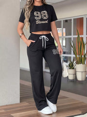 Front view of black 98 Blessed crop top and matching drawstring wide-leg pants