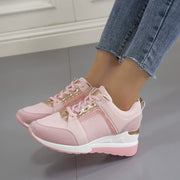 Pink lace-up wedge sneaker with white sole, side view