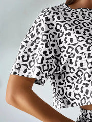 Close-up of the black leopard pattern and ribbed texture on the cropped short sleeve.