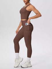 Brown tank and leggings shown from the front with one hand in pocket
