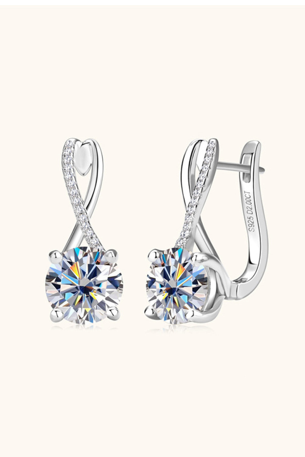 Silver-tone crossed-loop drop earrings angled to show the clear stones and clasps