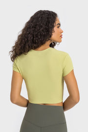 Back view of a pale yellow cropped sports T-shirt with short sleeves