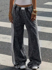 Back view of pink wide-leg track pants with striped trim