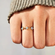 Blue-stone flower ring worn on a hand