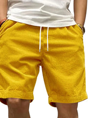 Model wearing yellow drawstring shorts, front view