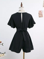 Back of black romper showing flutter sleeves and waist tie
