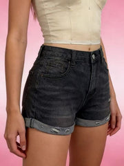 Model wearing black denim shorts with rolled cuffs