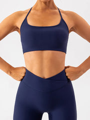Front view of navy ribbed active bra with hands at hips