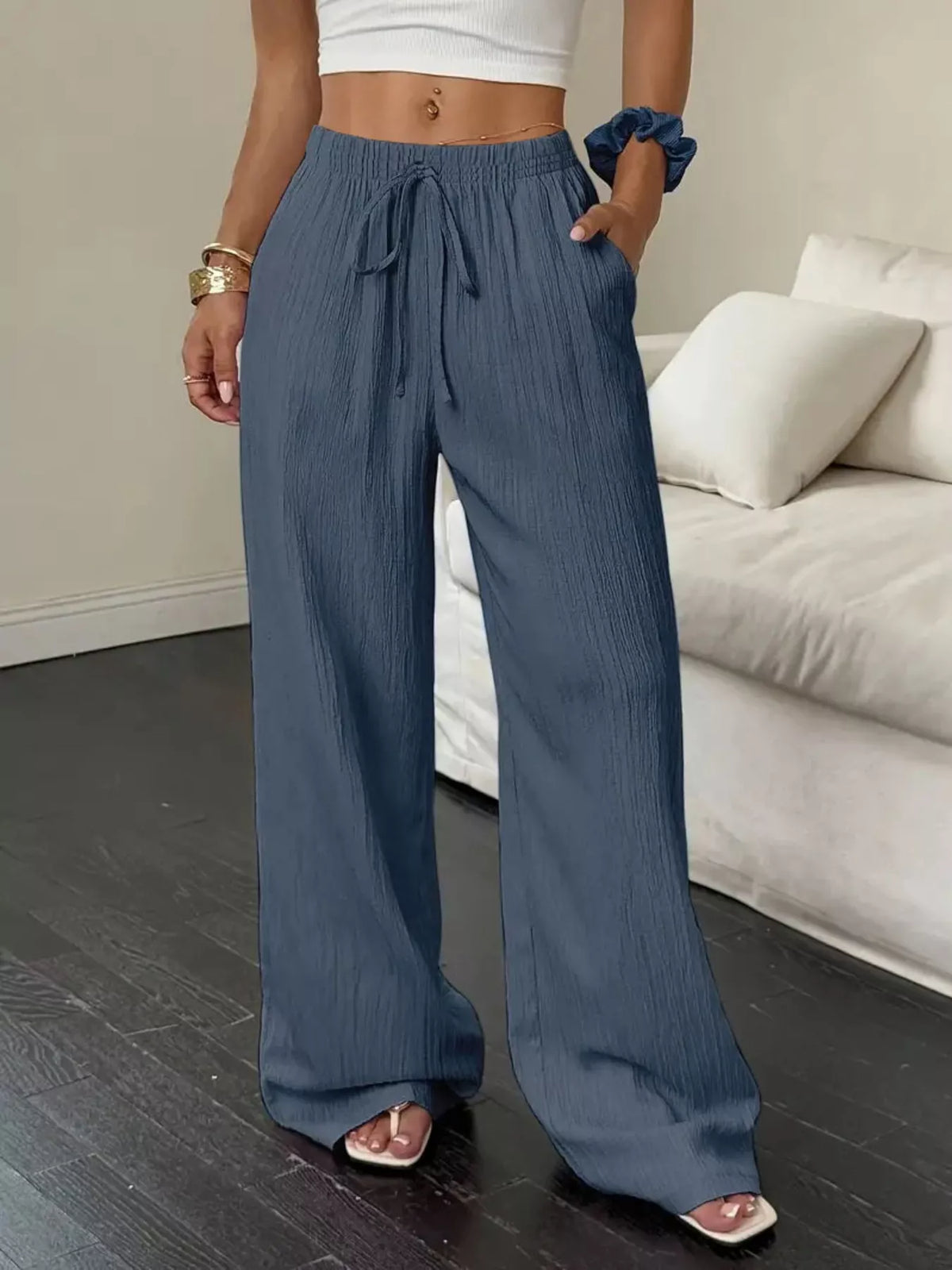 Back view of slate-blue wide-leg pants with gathered drawstring waist