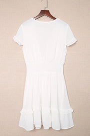 White dress displayed on hanger, back