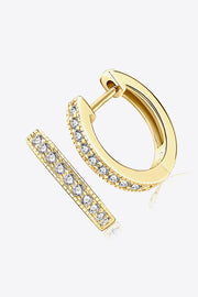 Angled view of gold-tone hoops with clear stones along the front edge