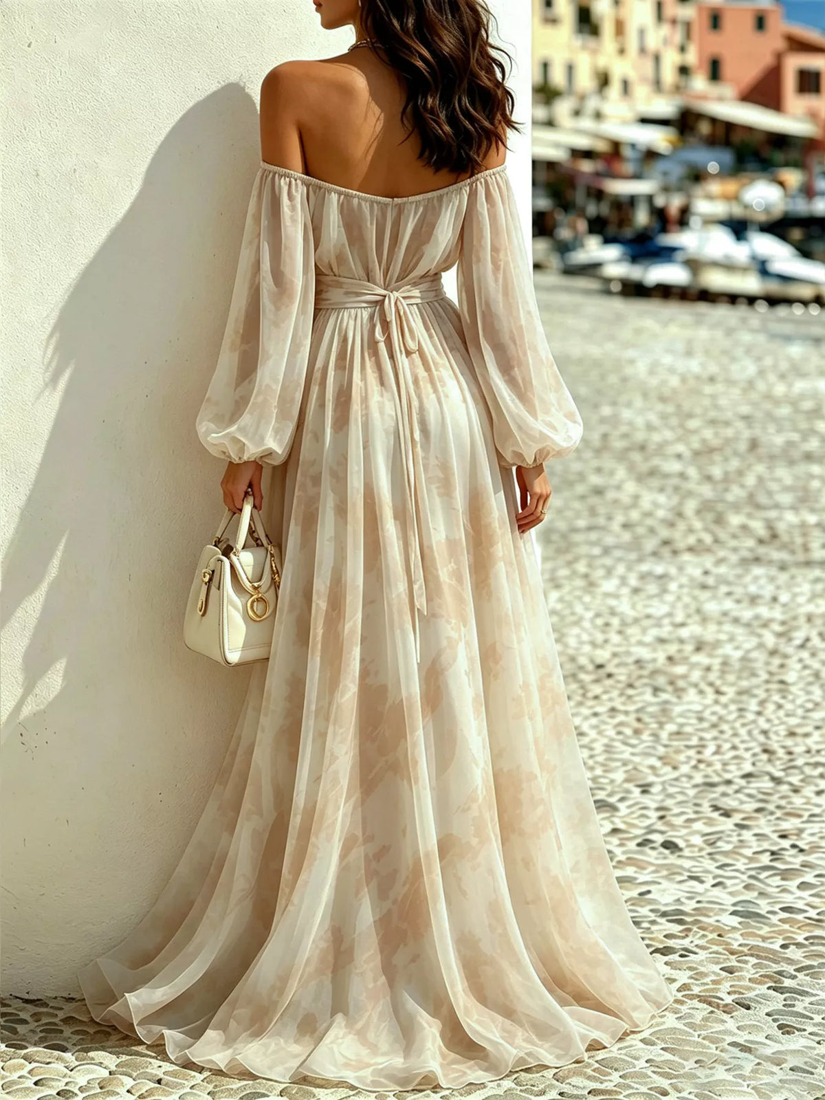Rear view of the cream maxi dress showing a tied waist and full skirt