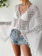 White tie-front crochet cover-up styled with denim shorts