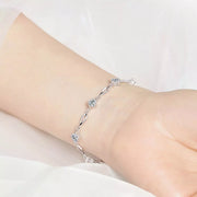 Close view of the silver-tone floral zircon bracelet worn around a wrist