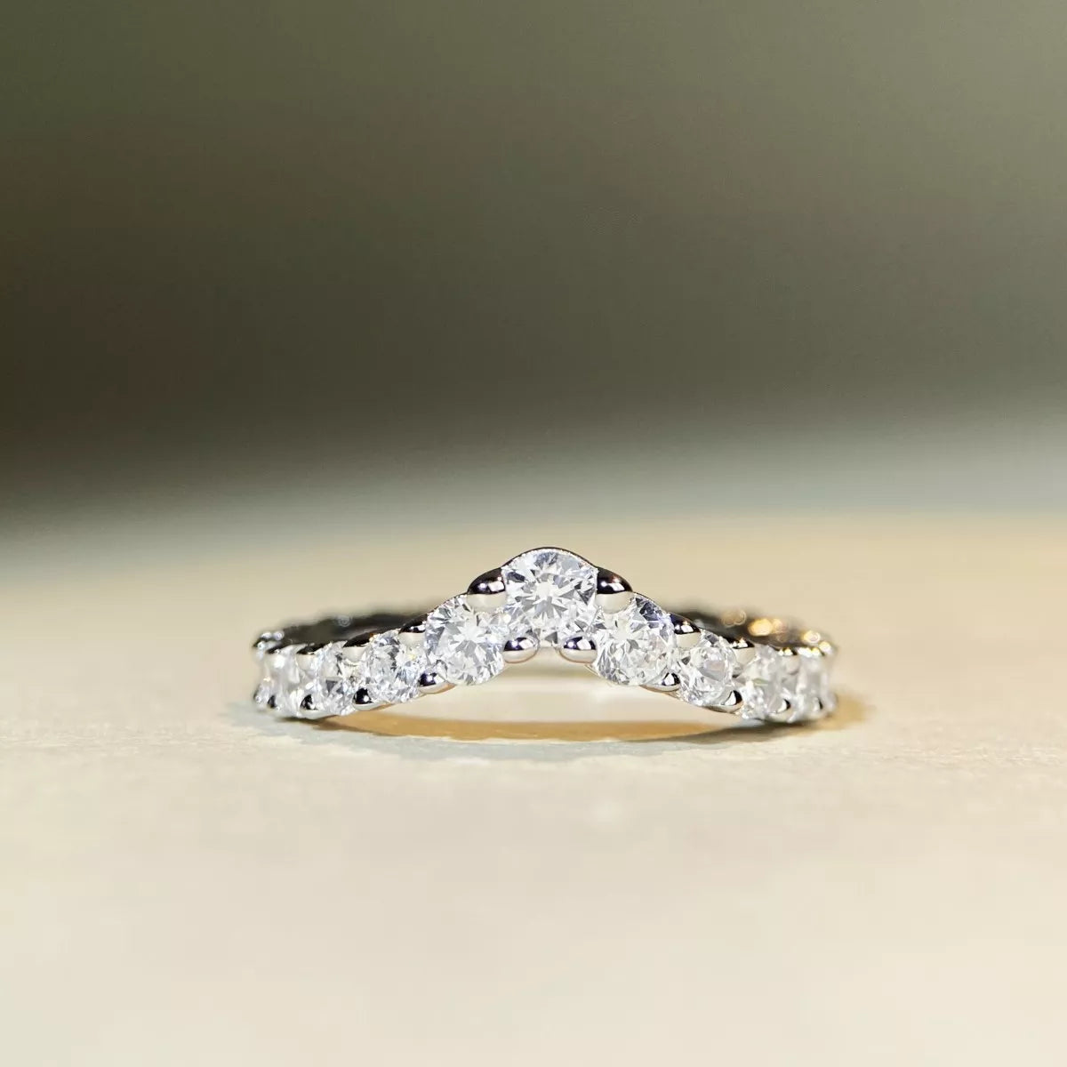 Low side view of the raised stones along the V-shaped ring.