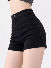 Model wearing black high-waisted denim shorts, side view