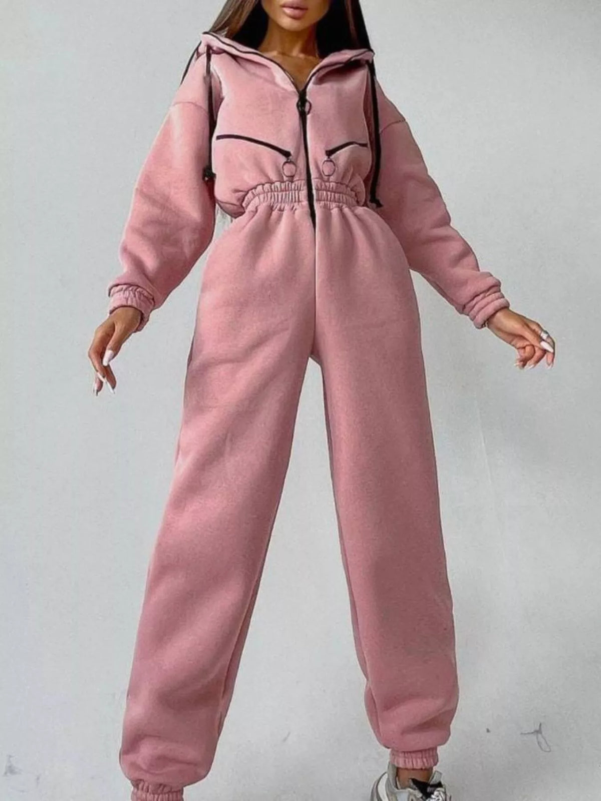 Women's rose pink hooded jumpsuit, model front pose with arms extended