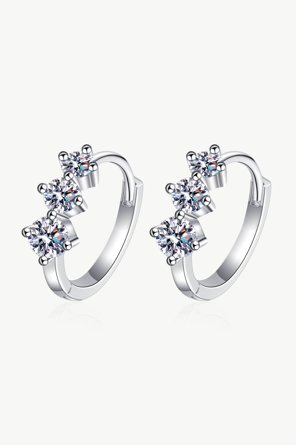 Pair of moissanite huggie earrings with stones along the front