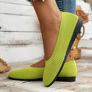 Lime green mesh slip-on flat shown in side profile on foot