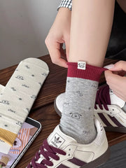 Gray sock being adjusted above a sneaker