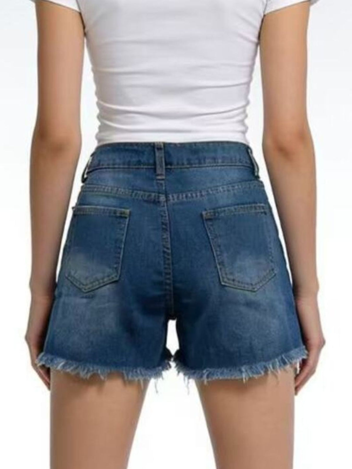 Rear view of blue denim shorts with belt loops, back pockets and frayed hems